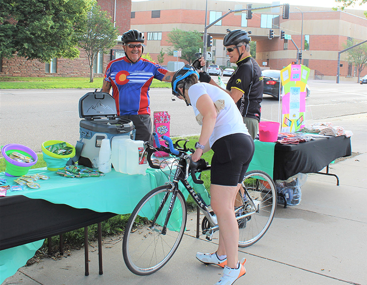 Three cyclists stopped for a water break