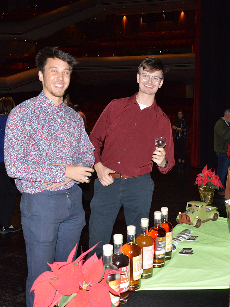 Photo of two gentlemen sampling whiskey