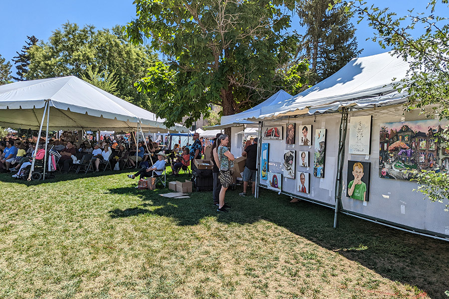 Photo of Greeley Arts Picnic patrons looking at an art booth