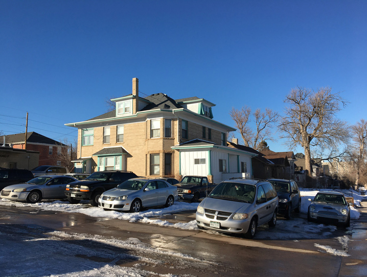 Photo of 3 story brick home converted to apartments with new entrance added